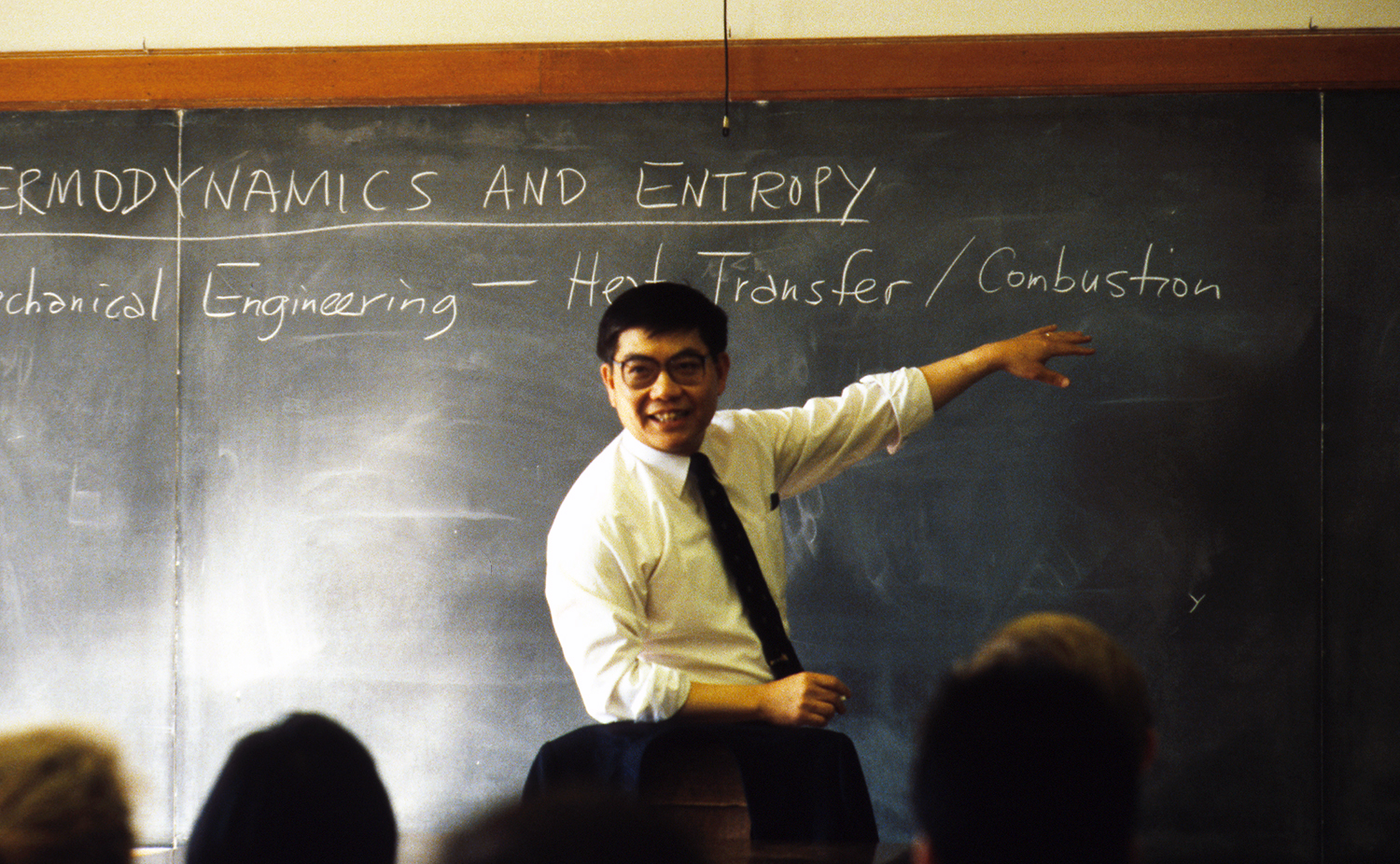 Chang-Lin Tien teaching in front of a blackboard